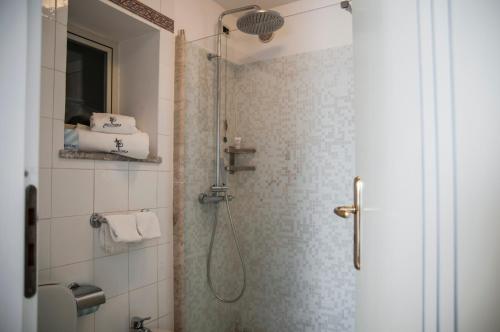 a bathroom with a shower with a glass door at Villa Le Terrazze Charming Rooms in Taormina