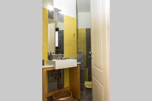 a bathroom with a sink and a mirror at Theo Pool Villa Magnificent Sea View in Kapandrítion