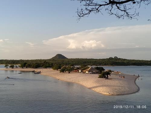 a group of people on a beach in the water at Alter do chão Caribe do Norte in Alter do Chao