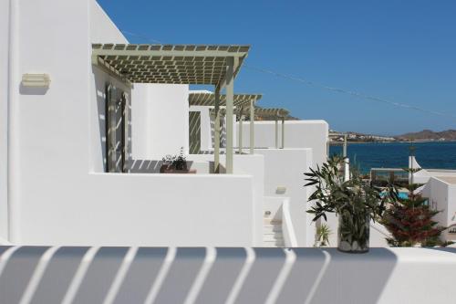 a white building with a view of the ocean at Saint Andrea Seaside Resort - Adults Only in Naousa