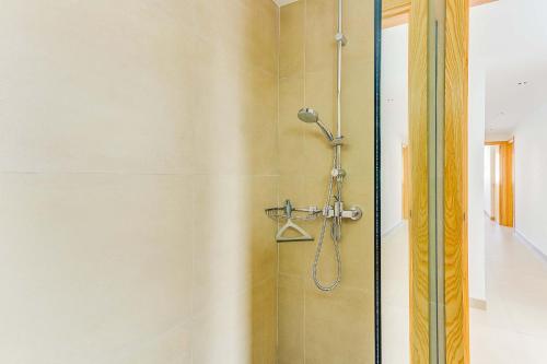 a shower with a shower head in a bathroom at Apartment Ca Na Xisca II in Can Picafort