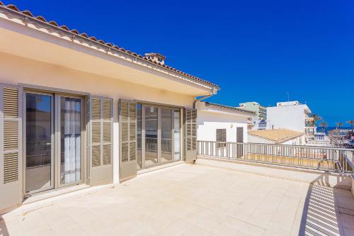 a balcony of a house with sliding glass doors at Apartment Ca Na Xisca II in Can Picafort