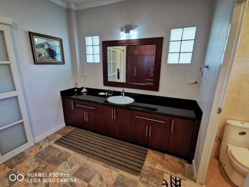 a bathroom with a sink and a mirror at Vacation Garden Villa in Thalang