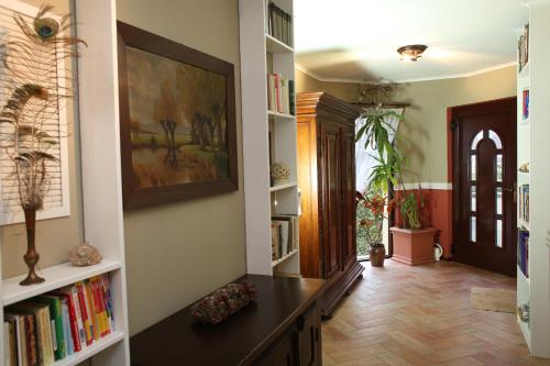 a hallway with bookshelves and a desk in a house at Logis Am Park in Dessau