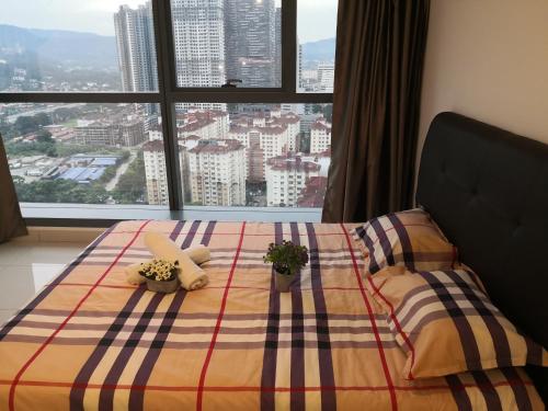 a bedroom with a bed with a view of a city at 3 Towers Duplex KLCC in Kuala Lumpur