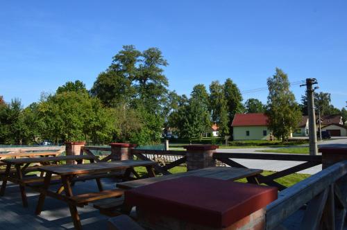 a group of picnic tables sitting on a patio at Penzion U podkováře in Třeboň