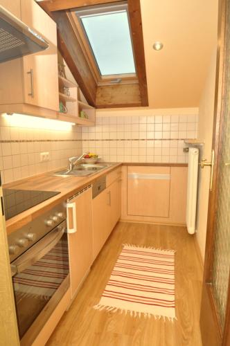 a small kitchen with a sink and a window at Appartementhaus Alpenrose in Wallgau