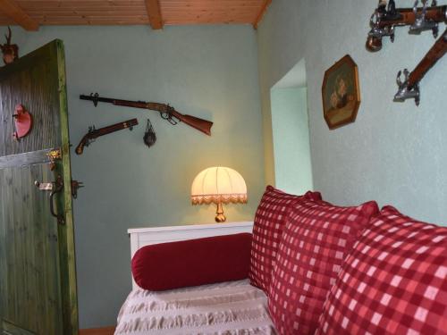 a room with a couch and a lamp and guns on the wall at Wohnung in Ribnitz Damgarten in Ribnitz-Damgarten