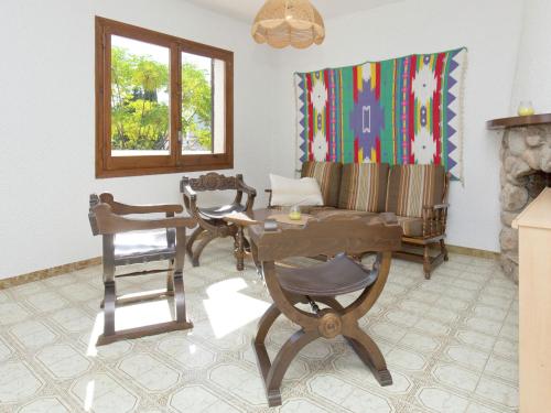a living room with a couch and a table and chairs at Apartment in Mont-roig near Sea Beach in Montroig
