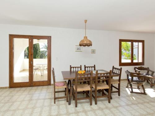 a dining room with a wooden table and chairs at Apartment in Mont-roig near Sea Beach in Montroig