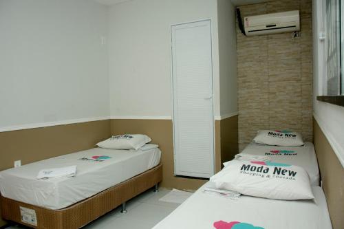 Cama o camas de una habitación en Pousada Moda New