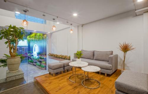 a living room with a couch and a table at Jomo in Ho Chi Minh City