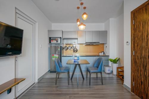 a kitchen and dining room with a table and chairs at Jomo in Ho Chi Minh City