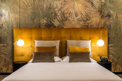 a bedroom with a large bed with a yellow headboard at Ca' Pagan in Venice