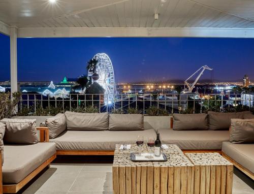 a living room with a couch and a ferris wheel at Queen Victoria Hotel by NEWMARK in Cape Town
