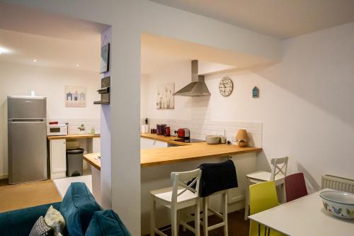 a kitchen with a counter top and a kitchen with a refrigerator at Cavernous open plan town house in st Leonards in St. Leonards