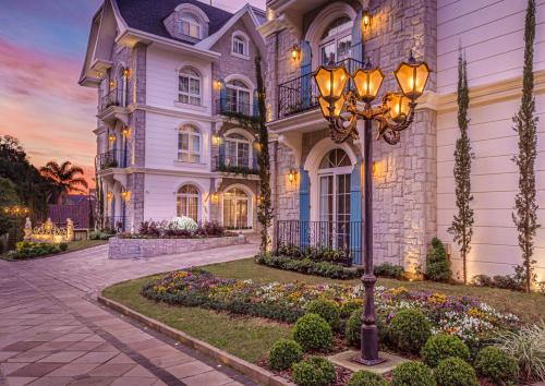 une maison avec un lampadaire devant dans l'établissement Hotel Colline de France, à Gramado