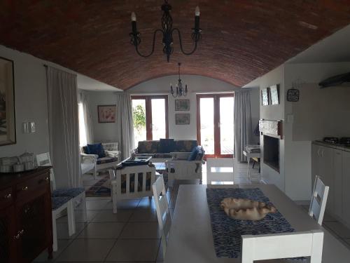 a kitchen and living room with a table and chairs at Paters Haven Self-catering and B&B in Paternoster