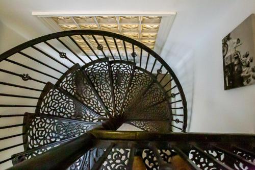 a spiral staircase in a house with a picture on the wall at Stylish modern Mews house in central St Leonards in Hastings