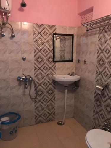 a bathroom with a sink and a shower at Purn Haveli in Jodhpur