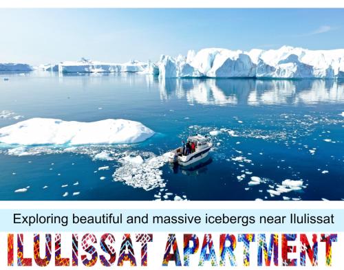 a boat in the water next to an iceberg at Ilulissat Apartment in Ilulissat