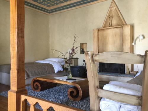 a bedroom with two beds and a fireplace in it at Artsistas Houses in Aristi