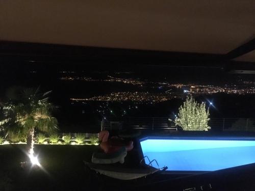 a view of a swimming pool at night at Villa Dreamcatcher in Katochori