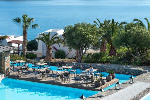 a view of the pool at the hotel at Aquila Elounda Village Resort, Suites & Spa in Elounda