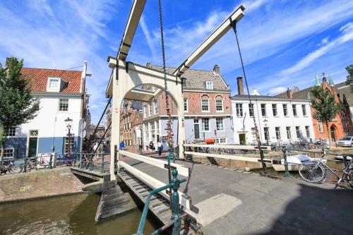 a crane lifting a bridge over a canal at The Amsterdam Hotel Apartment in the Center in Amsterdam