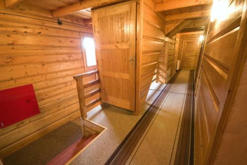 an inside view of a wooden cabin with a hallway at Pod Zielonym Bykiem in Witów