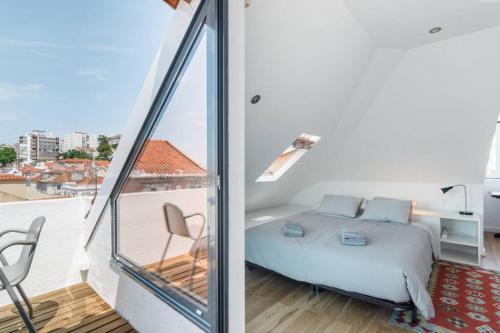 a bedroom with a bed and a balcony at Beautiful Apartment with View of the Tagus River in Lisbon