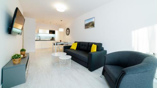 a living room with a couch and a table at Triventi Mountain Residence, Sun & Snow in Karpacz
