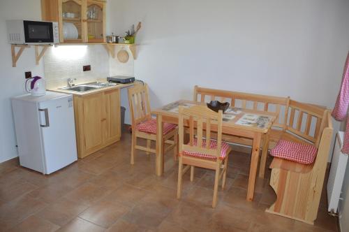 a kitchen with a table with a cat sitting on it at Penzion U podkováře in Třeboň