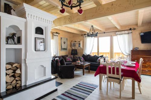 a living room with a couch and a table at TatryTop Osada Luxury Chalets Kościelisko in Kościelisko