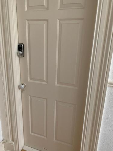 a white door with a silver knob on it at Upstairs Studio - Private kitchenette and Small en-suite in Dublin