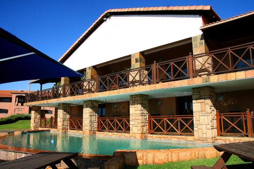 a building with a swimming pool in front of it at The Edwardian in Port Edward