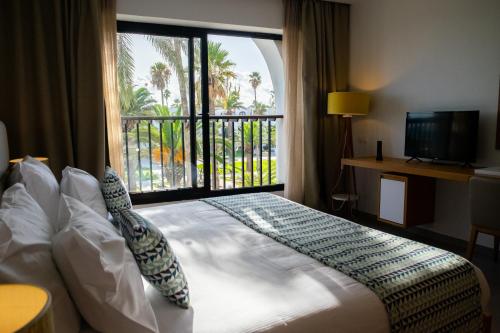 Letto o letti in una camera di Les Orangers Garden Villas and Bungalows Ultra All inclusive