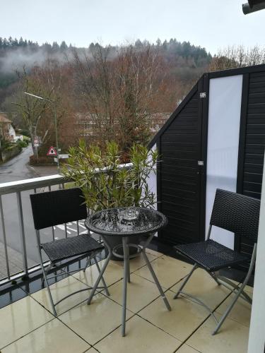 a patio table and chairs on a balcony at Hotel Ari in Kaiserslautern