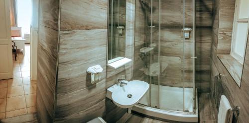 a bathroom with a sink and a shower at The Maltese Sun in Sliema
