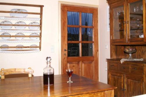 a glass of wine sitting on a table in a kitchen at Sarris House in Xirokámbion