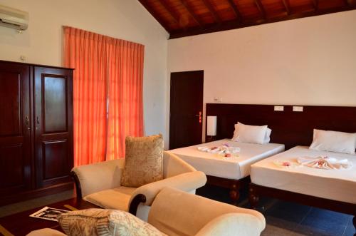 A bed or beds in a room at Marina Bentota