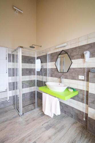 a bathroom with a sink and a shower at La Casa Di Alice in Rodello