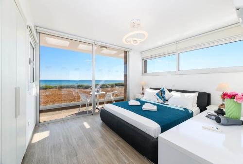 a bedroom with a bed and a view of the ocean at Infinity View Villa in Ayia Napa
