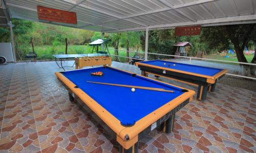 two ping pong tables sitting on a patio at Glamping Girardot & Hotel Puerta Del Sol Girardot in La Virginia