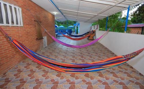 a room with two hammocks hanging from a wall at Glamping Girardot & Hotel Puerta Del Sol Girardot in La Virginia