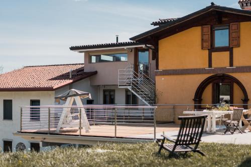 a chair on a deck in front of a house at B&B LUNA in Cornedo Vicentino