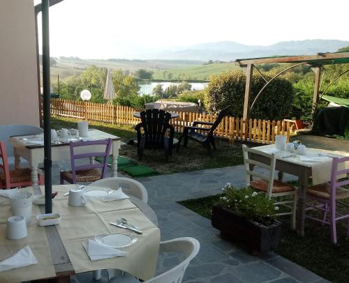 a patio with tables and chairs with a view at Il Marrondindo Bed & Breakfast in Galliano