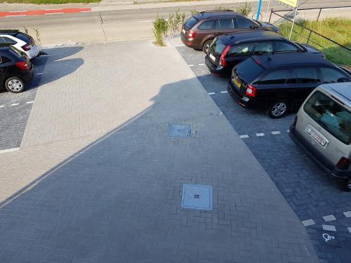 a group of cars parked in a parking lot at Hotel Amethist in Ramsel