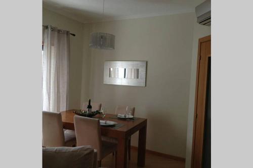 a dining room with a table with chairs and a dining room at Apartamento Varandas Soalheiras in Odeceixe