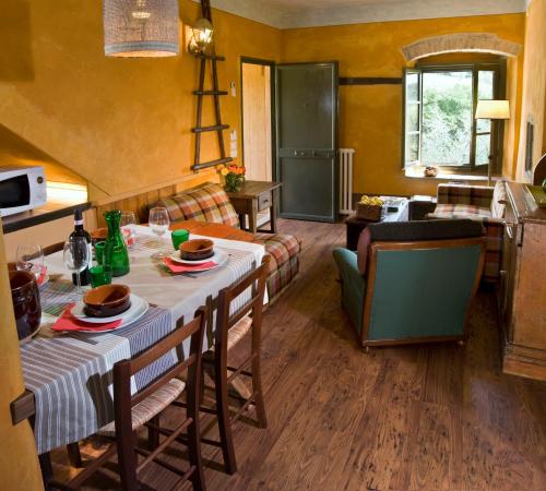a kitchen and living room with a table with food on it at I Veroni - Agriturismo and Wine Cellar in Pontassieve